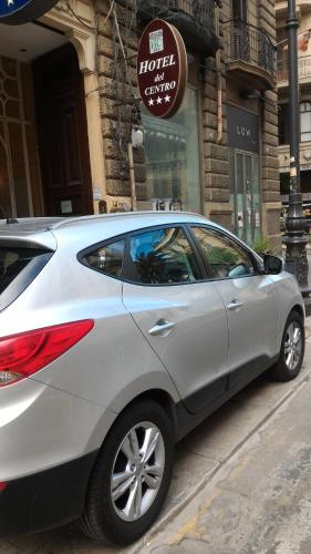 a silver car parked on the side of a street at Hotel del Centro in Palermo