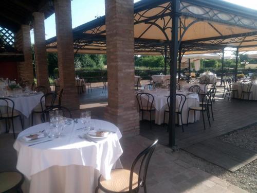 Cadè的住宿－Agriturismo Corte dei Landi，餐厅配有桌椅和白色的桌布