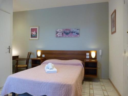 a bedroom with a bed with a towel on it at Lou Garbin in Saint-Laurent-dʼAigouze