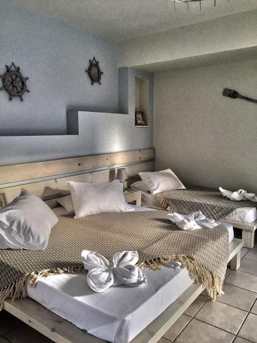 a bedroom with two beds with flowers on them at Aegean Paradiso Vacation Club - "Adults Only" in Azolimnos