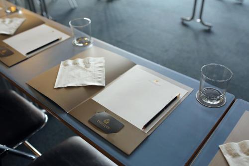 a table with two glasses and a napkin on it at Etoile de Pompadour in Arnac-Pompadour
