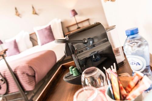 a bedroom with a bed and a sink with a sink at Charmehotel Klokkenhof in Brasschaat