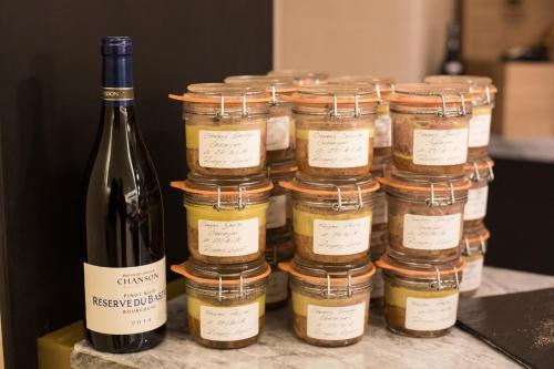 a bunch of jars of food and a bottle of wine at Etoile de Pompadour in Arnac-Pompadour