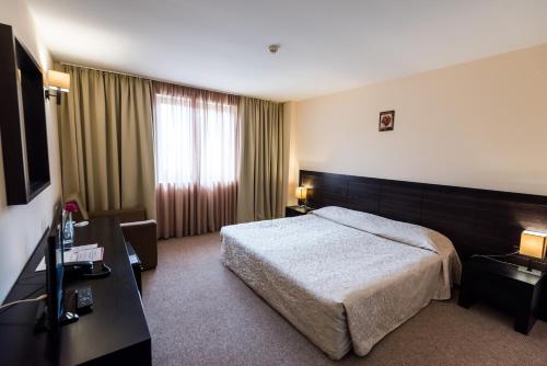 Gardenia Park Hotel tesisinde bir odada yatak veya yataklar