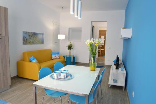 a living room with a table and chairs and a couch at Appartamento Nonna Lina in Custonaci