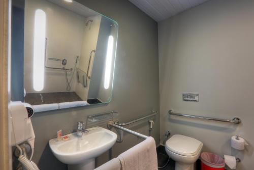 a bathroom with a sink and a toilet and a mirror at ibis Sinop in Sinop