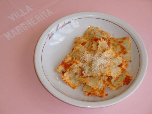 a white plate of food on a pink table at Albergo Villa Margherita in Tiglieto