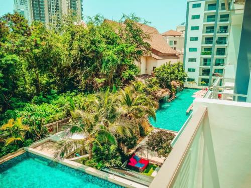 an aerial view of a resort pool with palm trees at Club Royal suites in North Pattaya
