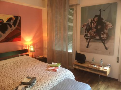 une chambre avec un lit et une télévision dans l'établissement Casa Albert, à Bologne