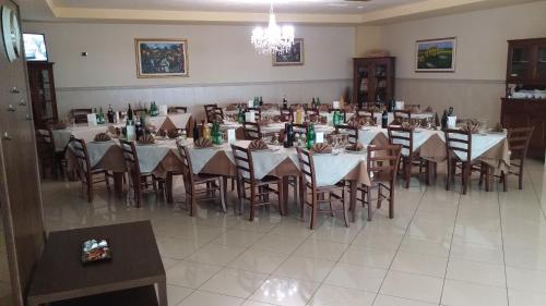 a group of tables and chairs in a room at La Piana Hotel in Tito