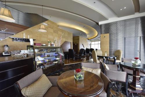 a dining room with a table and chairs at Awaliv Hotel in Taif