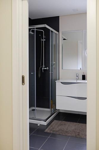 a bathroom with a shower and a sink at Sunset Holiday Home in Fernao Ferro