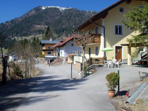 a house with a table and chairs in a driveway at Haus Mary in Russbach am Pass Gschütt