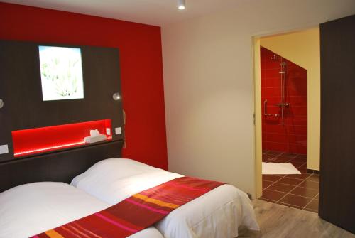 a red bedroom with a bed and a shower at Logis Hôtel & Restaurant Les Perce-Neige in Bonnétage