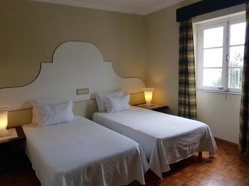 Ένα ή περισσότερα κρεβάτια σε δωμάτιο στο Hotel de Moura