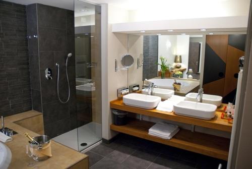 a bathroom with two sinks and a shower at Admiral Park Hotel by Falco D'Oro Hotels in Zola Predosa