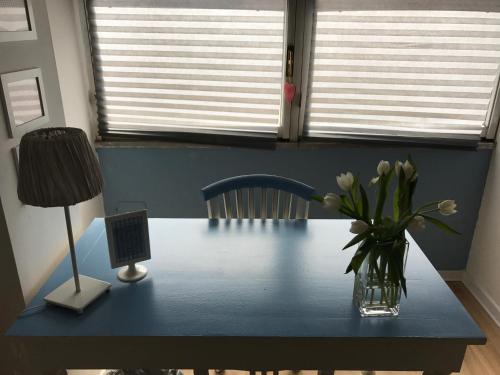 a vase of flowers on a table with a lamp at RighePois in Reggio Calabria