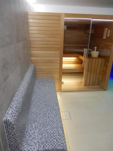 a bathroom with a bench in front of a closet at Villa Mediterana in Seget Vranjica
