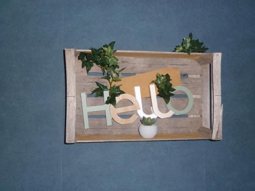 a wooden sign with the word fire with a potted plant at pastelle in Contres