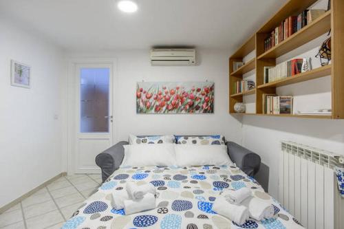 a bedroom with a bed and a book shelf at Casa San Marcellino in Naples