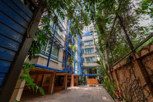 an empty alley in a city with tall buildings at Silom Convent Garden in Bangkok