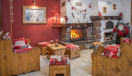 a living room with a fireplace and christmas decorations at Logis Hôtel Le Vétiné in Le Valtin