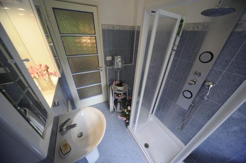 a bathroom with a shower and a toilet and a sink at Il Guscio in Baveno