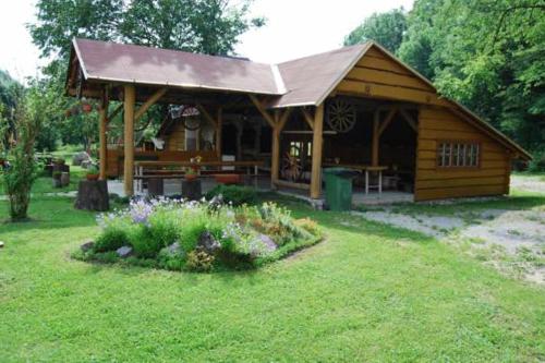 a wooden cabin with a garden in the yard at Penzión Šuštiak in Terchová