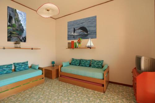 a room with two beds and a tv at terrazza metese in Meta