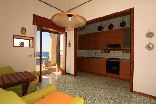 a living room with a kitchen and a dining room at terrazza metese in Meta