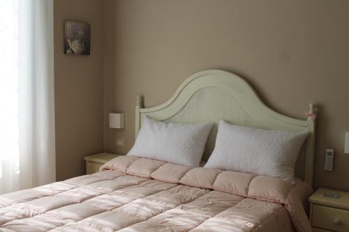a bedroom with a large bed with a large headboard at B&B Paura in Naples