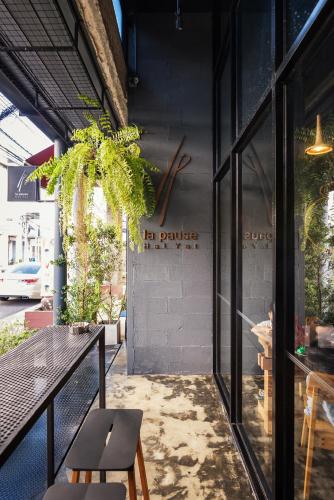 a patio with a table and chairs in a building at La Pause Hatyai in Hat Yai