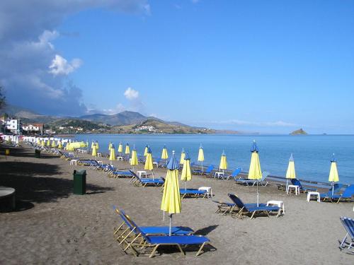 a bunch of chairs and umbrellas on a beach at Hotel Ilion in Petra