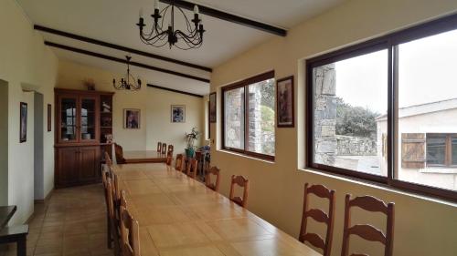 a dining room with a long table and chairs at L'Albadu in Corte