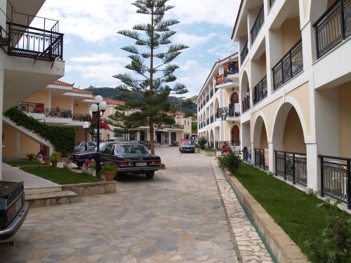 a car parked on a street next to some buildings at Castello Beach Hotel in Argasi
