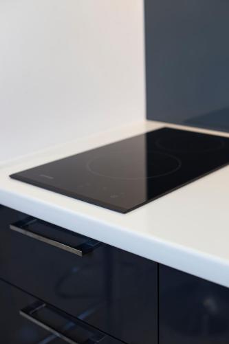 a white desk with a tablet on top of it at Dia Belgrade Arena Apartment in Belgrade