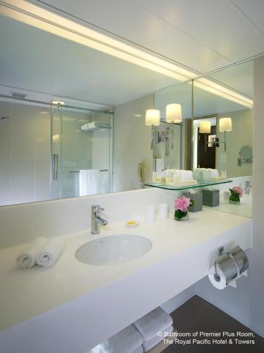 a bathroom with a sink and a large mirror at The Royal Pacific Hotel & Towers in Hong Kong