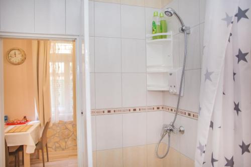 a bathroom with a shower curtain with stars on the wall at Apartment BARBARA - BOJANA in Šibenik