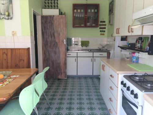 a kitchen with a sink and a stove top oven at Leo's Den in Fish hoek