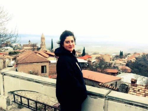 a woman standing on top of a building at Lia's Guest House in Sighnaghi