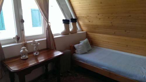 a small room with a bed and two windows at Holiday Home Stella in Žabljak