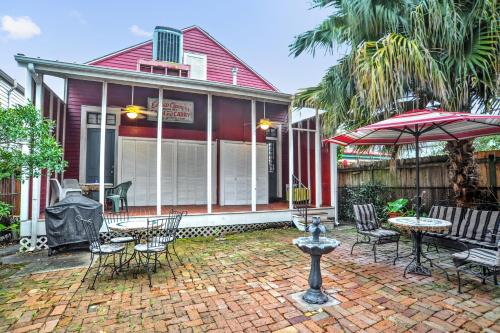 a house with a patio with chairs and an umbrella at The Burgundy Bed and Breakfast in New Orleans