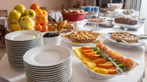 a table topped with plates and bowls of fruit at Hotel Settentrionale Esplanade in Montecatini Terme