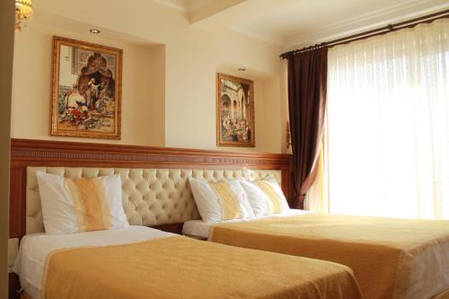 a hotel room with two beds and a window at Blue Istanbul Hotel in Istanbul
