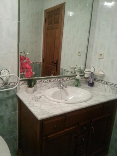 a bathroom with a sink and a mirror at Casa Luna Lunera in Ayllón