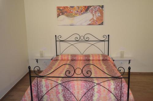 a bedroom with a bed and two night stands at B&B Il Vicoletto in LʼAquila