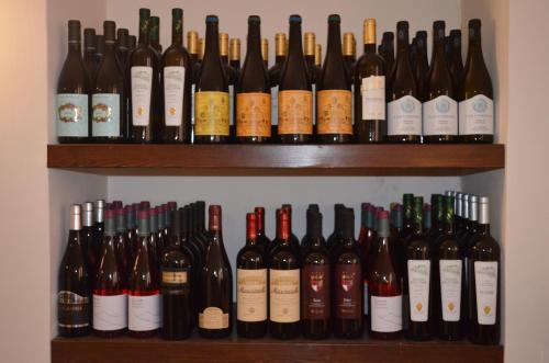 a bunch of bottles of wine on shelves at B&B Il Vicoletto in LʼAquila