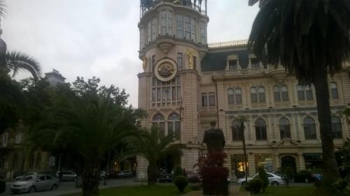 a large building with a clock tower on top of it at OldBatumi Apartment in Batumi