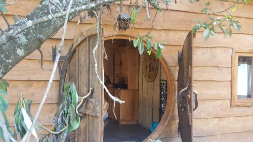 a door to a log cabin with a surfboard at Vientos de Chauquen in Panguipulli