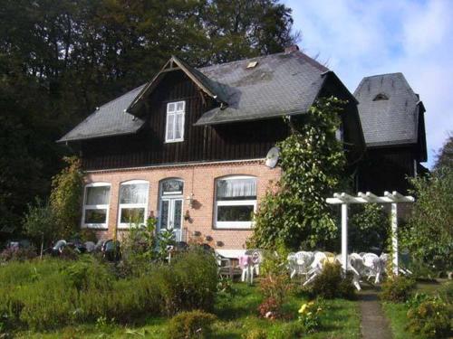 a brick house with a black roof at Landhaus Eickhof in Niederhaverbeck